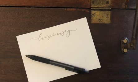 Personalized stationery and pen on writing desk