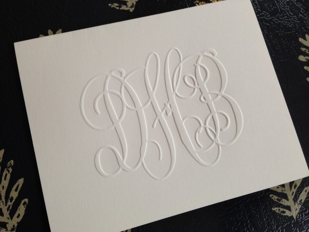 Classic monogram features a large center initial