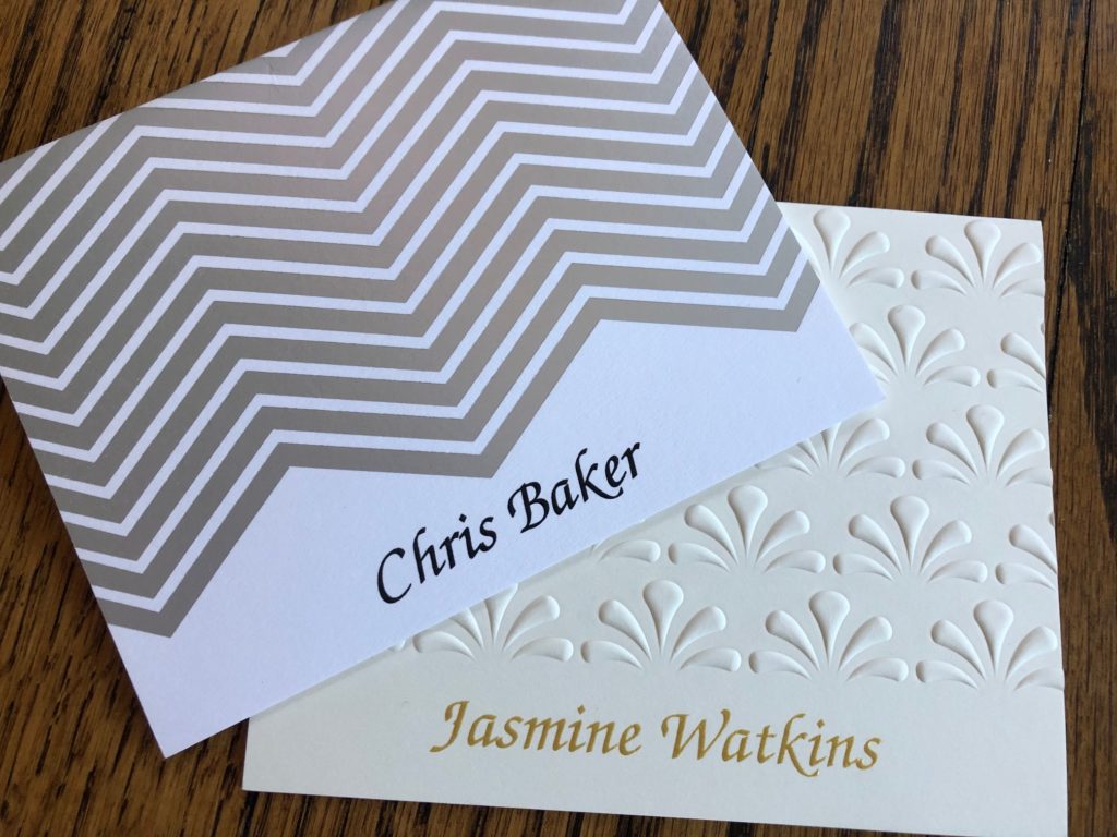 Two personalized folded notes from Embossed Graphics featuring names printed in black and gold raised ink.