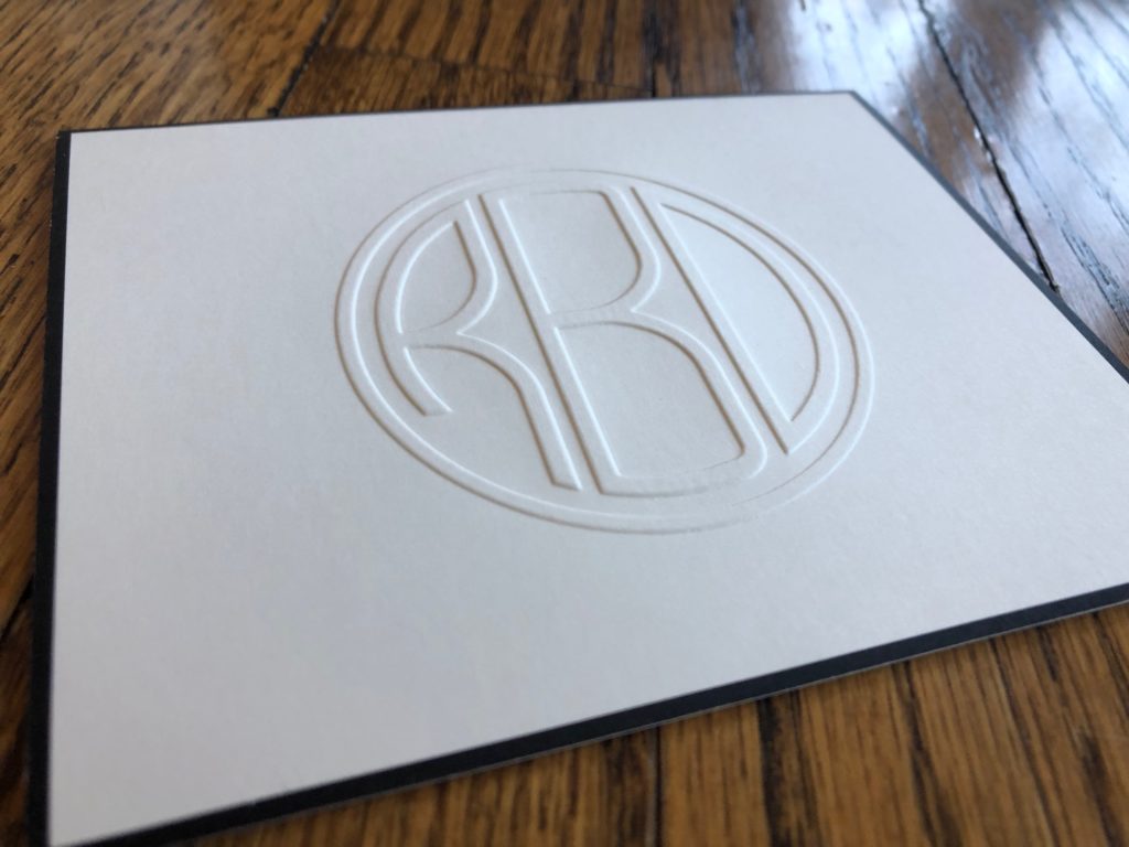 A monogrammed folded note from Embossed Graphics with a black border to give it more sophistication.